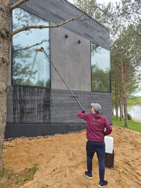 Tall house windows being cleaned